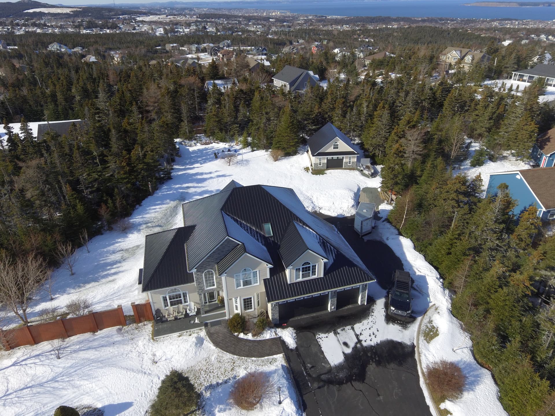 Overhead steep-slope view showing valley flashings, hips, and skylight integration
