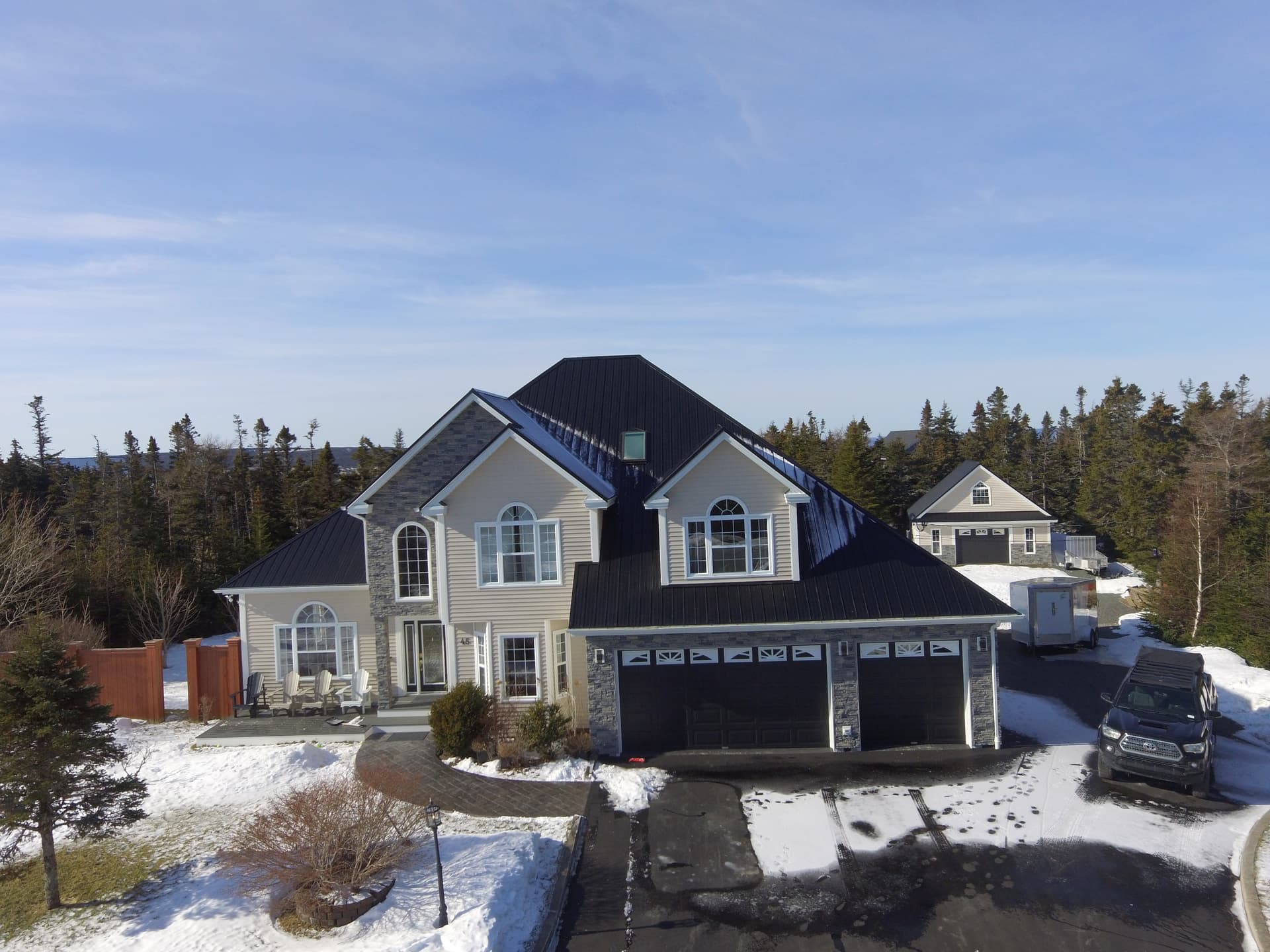 Completed luxury residential metal roof in winter snow - Front Elevation